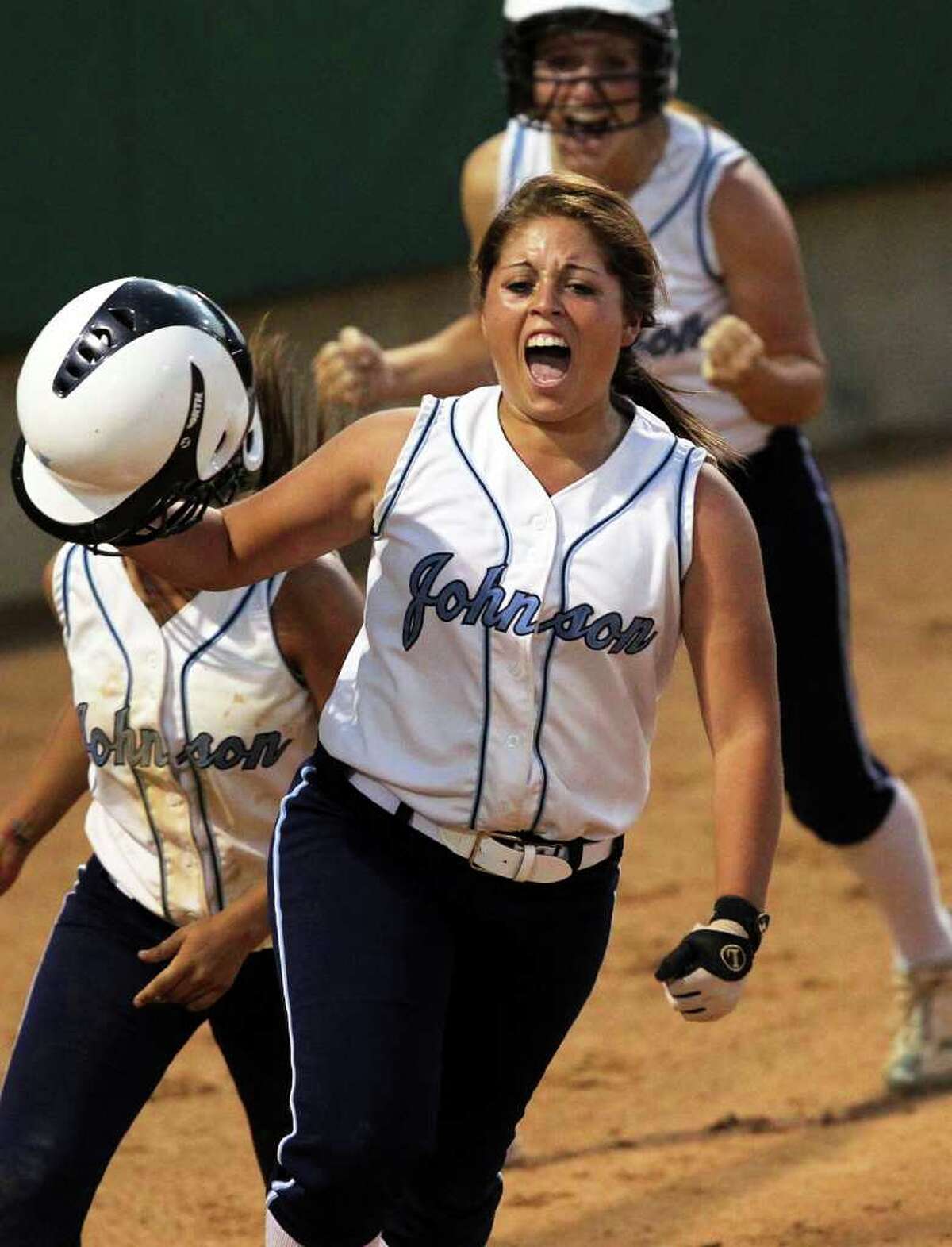 SPORTS Johnson's Geena Garcia runs back to the dugout celebrating after hitting a grand slam home run as her team beats Taft 5-2 during round 2 at Northside Field #2 on May 5, 2011. Tom Reel/Staff