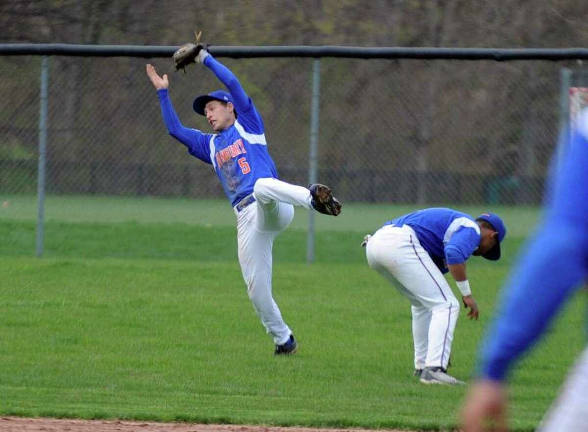 Danbury's Robbie Meerman makes a catch as he dives backwards during Wednesday's game at Greenwich High School on April 20, 2011.