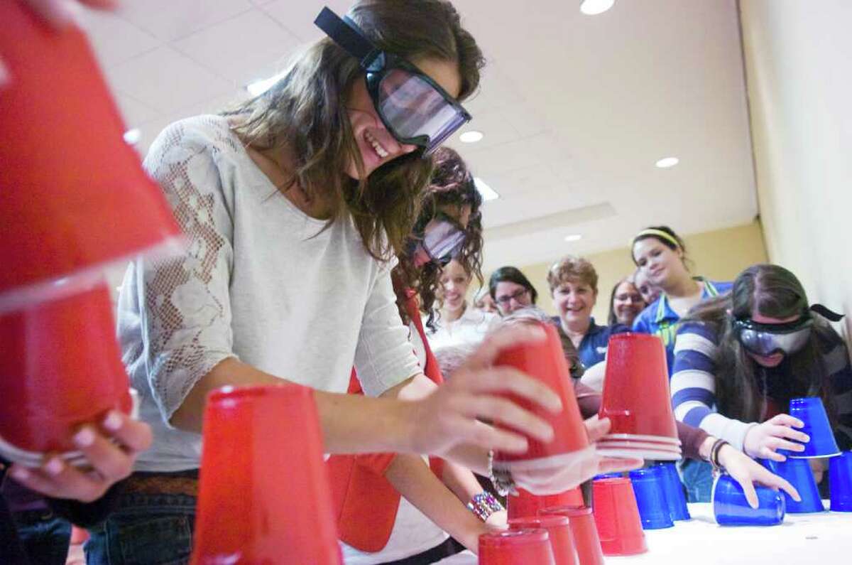 Au pair Anais Dumont of France runs through tests wearing goggles to simulate alcohol intoxication as the Automobile Association of America and Au Pair in America team up for a program to help au pairs become better drivers at the Holiday Inn Select in Stamford, Conn., May 8, 2011. The program covered American laws regarding child seats, street signs, and alcohol intoxication.