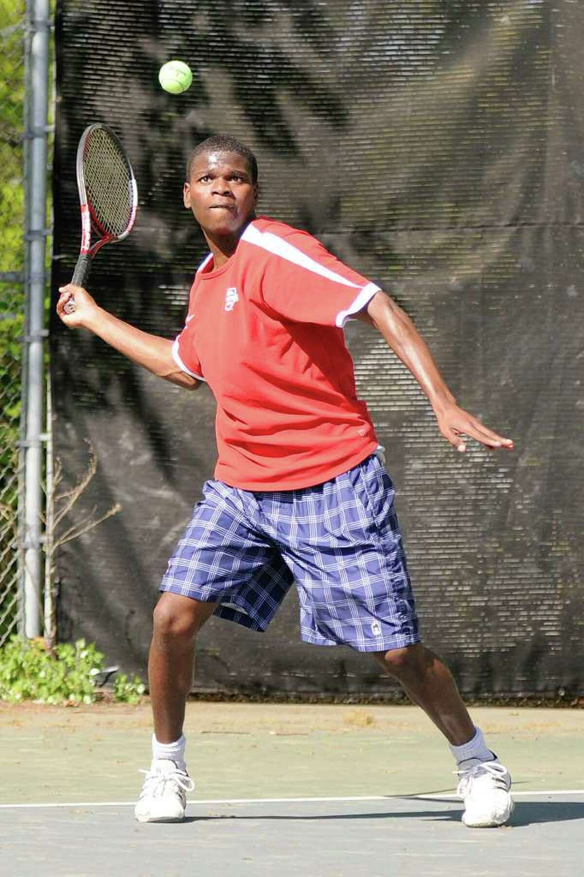 McMahon's Dreshawn Lewis returns a volley in a boys varsity tennis match as Brien McMahon High School hosts Fairfield Ludlowe High School in Norwalk, CT on Monday May 9, 2011.