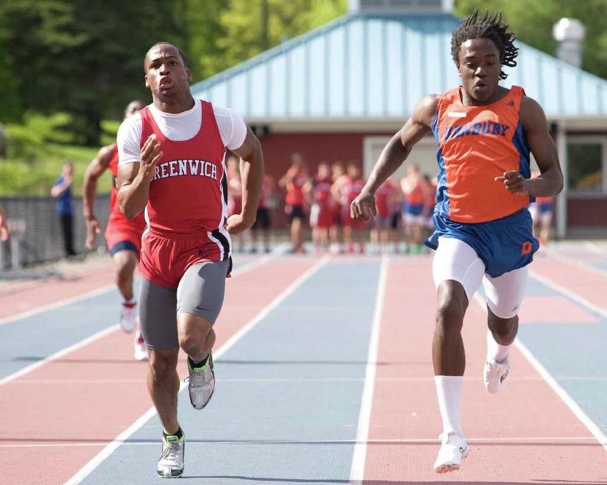 Danbury's Daryle Michael Dennis, right, nips Greenwich's Tim Frazier in the 100 meters Tuesday at Danbury High School.