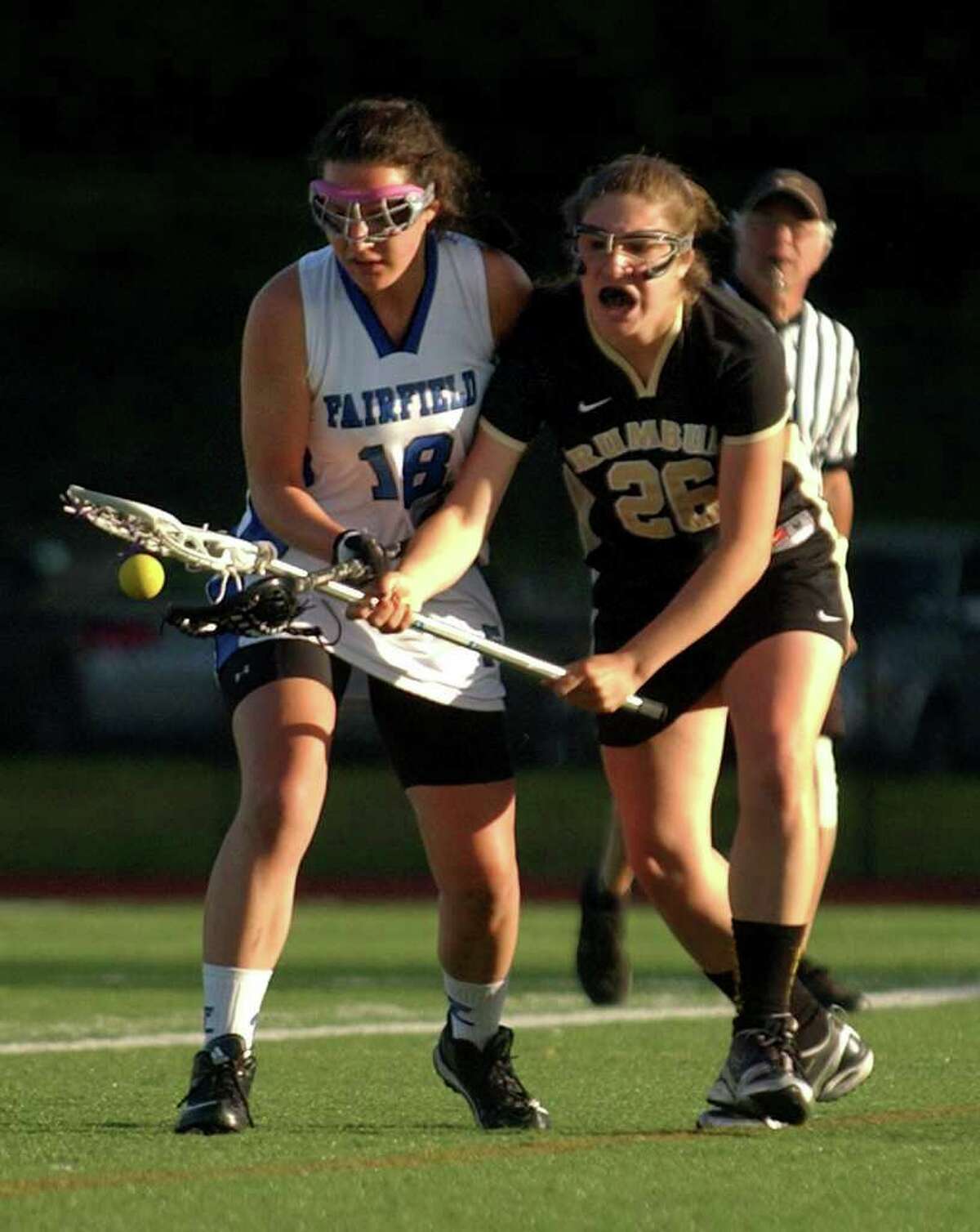 Fairfield Ludlowe's #18 Meredith Petralia, left, and, Trumbull's #26 Ally Tuozzoli, scramble for the ball, during girls lacrosse action in Fairfield, Conn. on May 10, 2011.