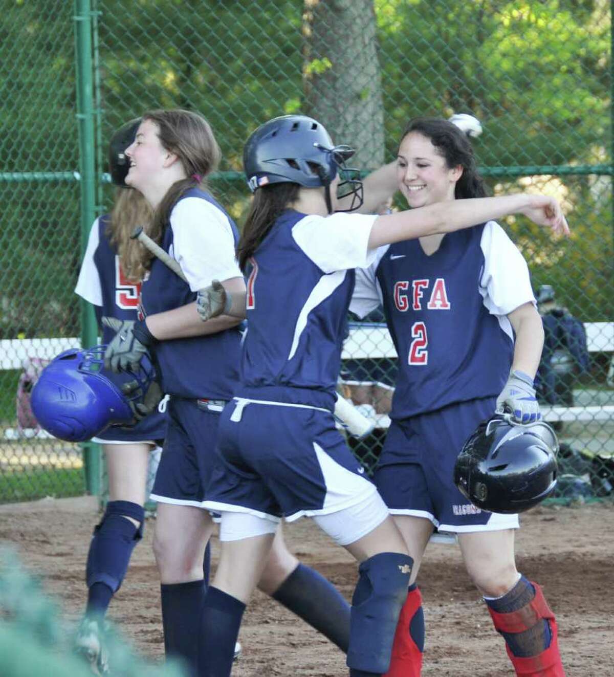 Greens Farms Academy senior captain Idalia Friedson, right, is congratulated by sophomore Miranda Princi after hitting a grand slam home run in a 15-11 victory over Holy Child last week. Friedson will play softball next year for Amherst College.