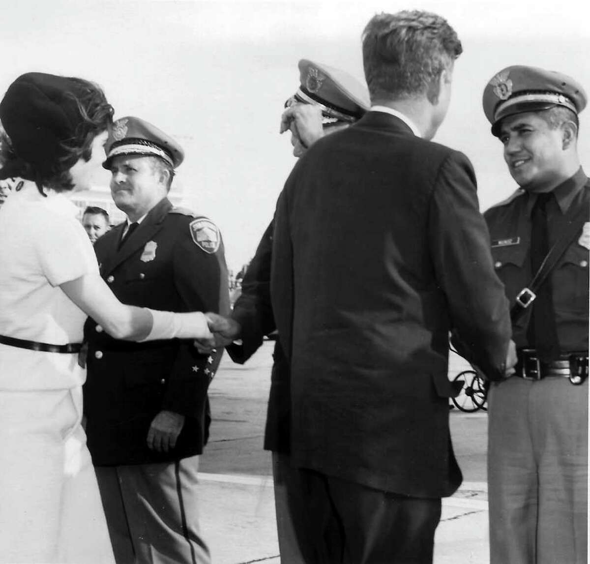 President and Mrs. John F. Kennedy in San Antonio, Texas during his visit November 21, 1963 visit. On the right shaking JFK's hand is SAPD officer Johnny Munoz.