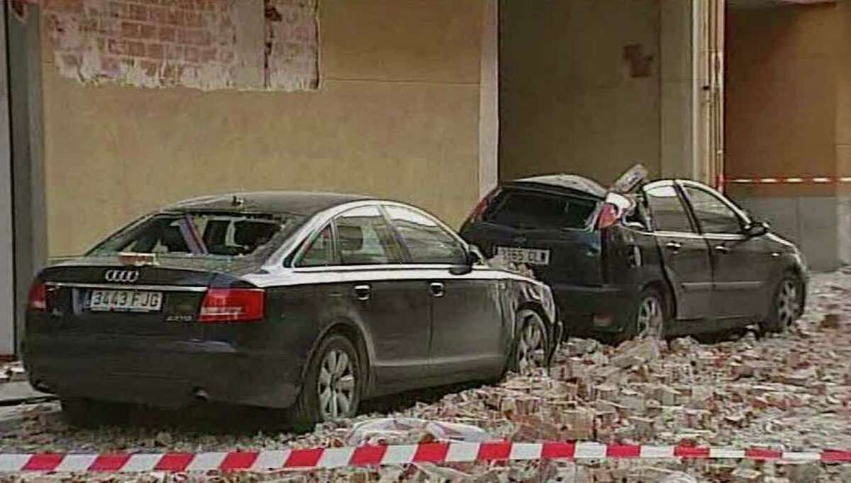 Damaged vehicles and debris are seen on the street after an earthquake in Lorca Spain in this image taken from TV Wednesday May 11, 2011. Two earthquakes struck southeast Spain in quick succession Wednesday, killing several people, and injuring dozens and causing major damage to buildings, officials said. The epicenter of the quakes with magnitudes of 4.4 and 5.2 was close to the town of Lorca, and the second came about two hours after the first. (AP Photo/Atlas TV, via APTN) TV OUT SPAIN OUT