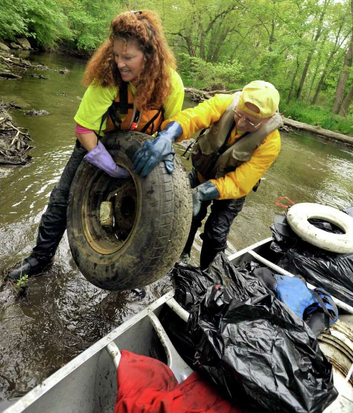 Susan Tomanio, of Bethel, and Ed Foss, of Bridgewater, clean up the Still River in Brookfield during the Seventh Annual Still River Waterway and Greenway Cleanup, Saturday, May 14, 2011.
