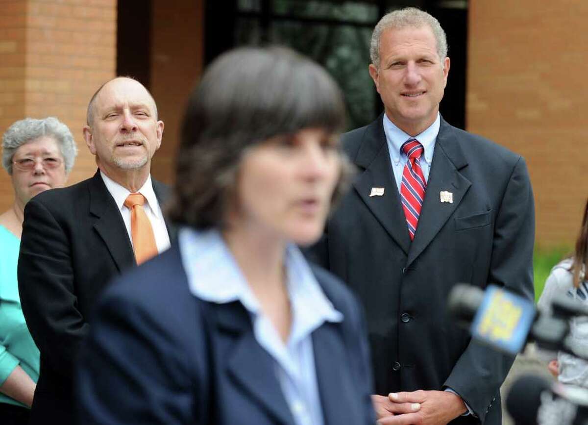 School Superintendent Freeman Burr, left, and Mayor Mark Lauretti listen as Shelton High School Headmaster Dr. Beth A. Smith announces James Tate will be allowed to go to the Shelton High School prom after all during a press conference Saturday, May 14, 2011. The senior was banned from the prom for posting a message May 6 on the school building made with cut-out letters asking friend Sonali Rodrigues to be his date.