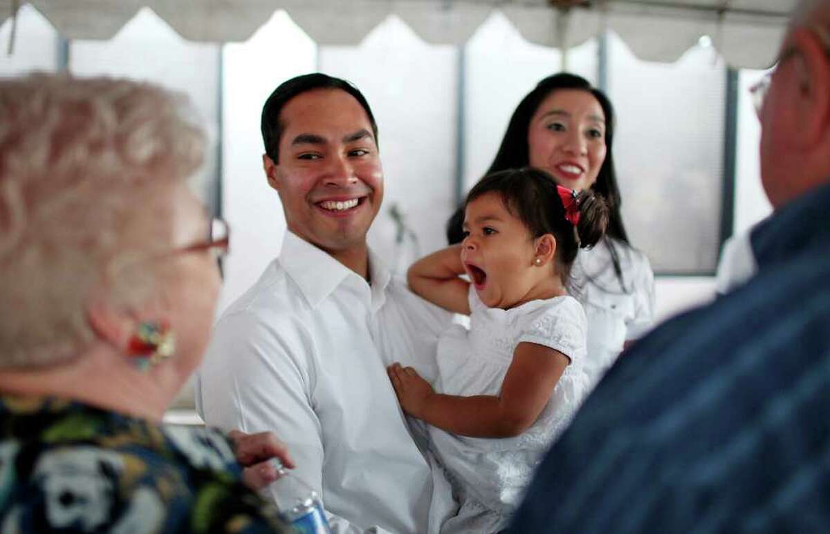 Mayor Julián Castro his 2-year-old daughter Carina and wife Erica (background) greet supporters at his campaign headquarters on Saturday, May 14, 2011.