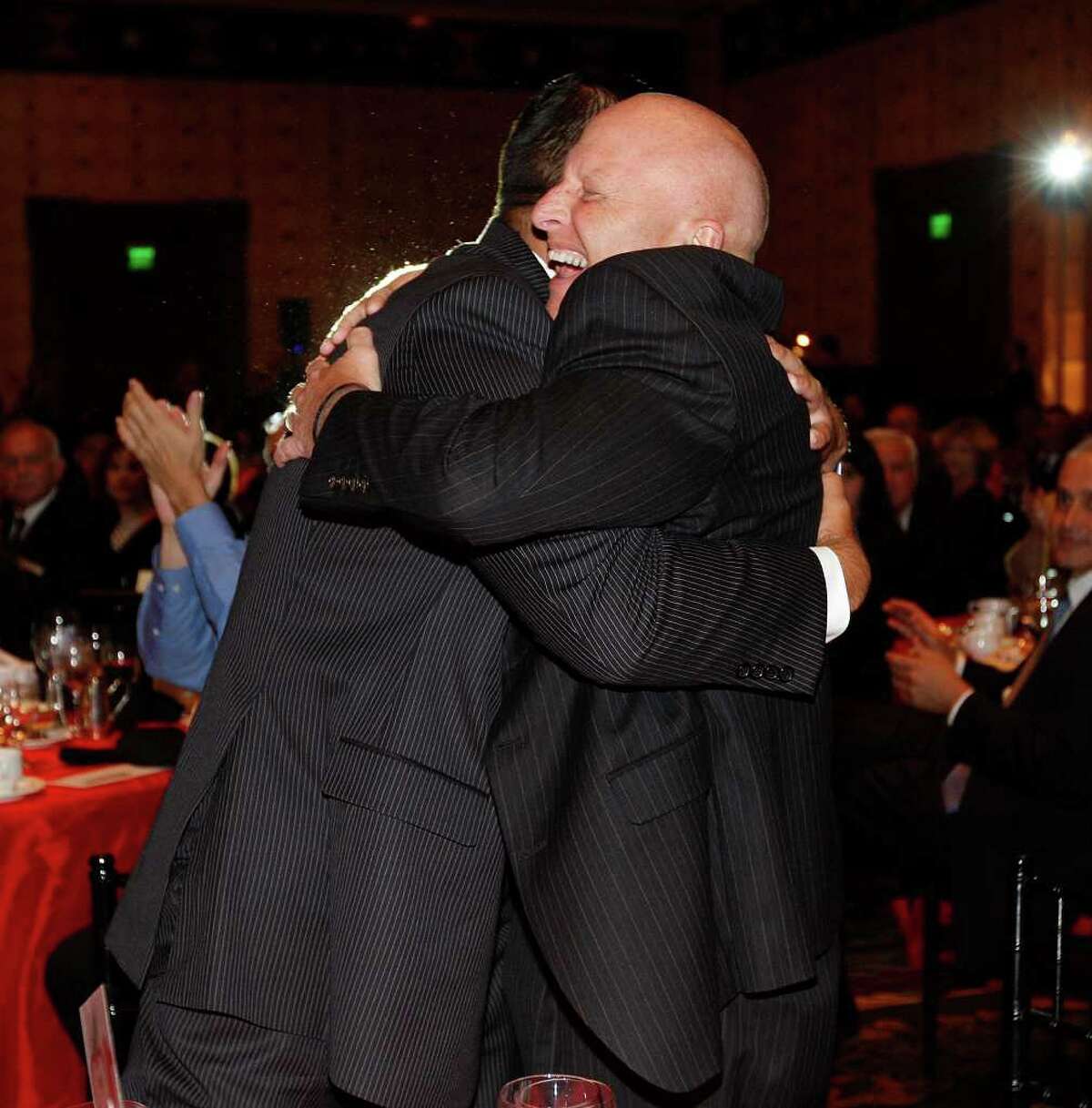 Harlandale ISD Superintendent Robert Jaklich, right, hugs Board President Anthony Alcoser after the district won the Large District category of the 10th annual H-E-B Excellence in Education Awards in Austin on Sunday. JERRY LARA/glara@express-news.net
