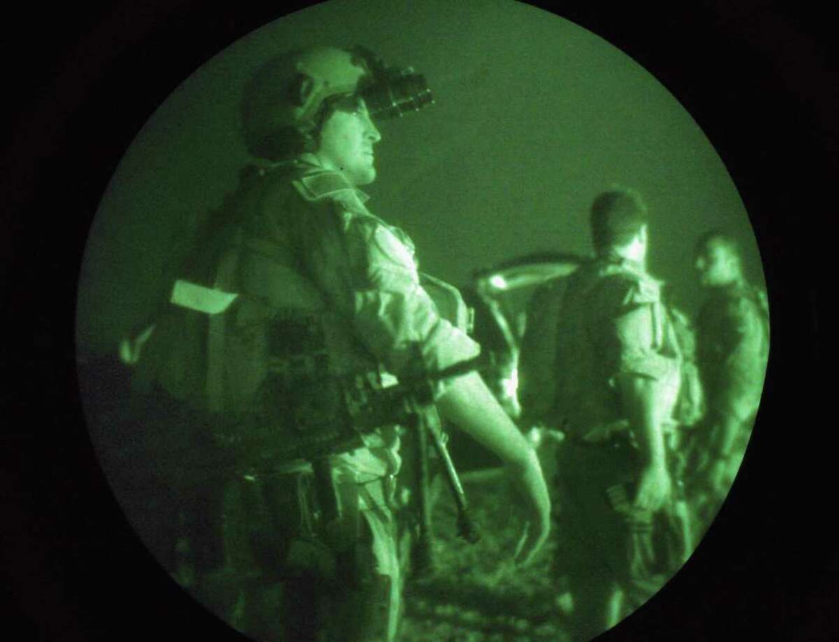 FALLUJAH, IRAQ - JULY 27: U.S. Navy SEALS await a night mission to capture Iraqi insurgent leaders July 27, 2007 near Fallujah, Iraq. American Special Forces operate throughout Iraq, targeting "high-value targets" in commando raids, often at night to take advantage of their night vision superiority. (Photo by John Moore/Getty Images)