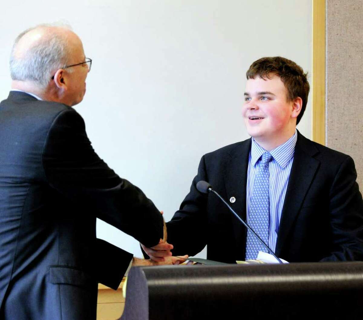 Greenwich Time editor David McCumber, shakes hands with Greenwich High School junior William Hallisey, who was named the first place winner of the second annual Defining Diversity Writing Contest. The award ceremony, sponsored by Greenwich Time and the Town of Greenwich, was held at Greenwich Library, Tuesday afternoon, May 17, 2011.