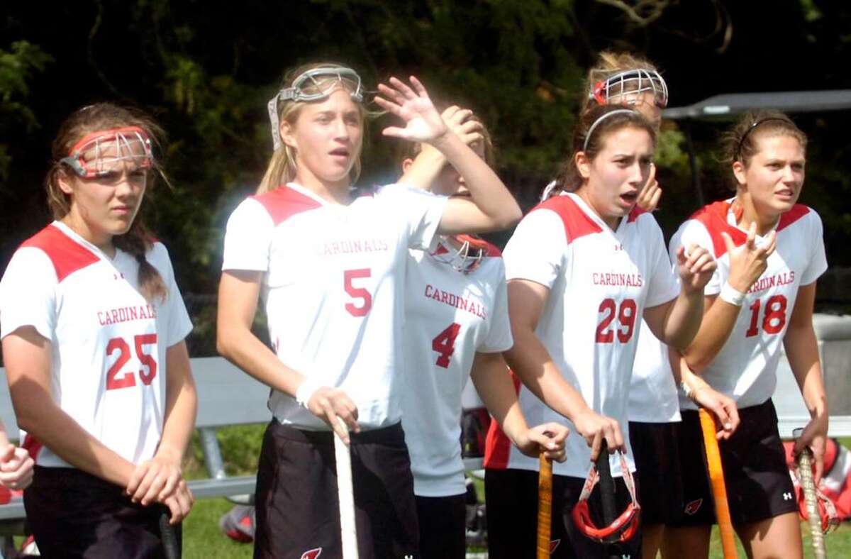 Tension on the Greenwich sideline as Jen Renz, center, and teammates wait out a nail biter against Cheshire High resulting in a scoreless overtime. The Greenwich High field hockey game against Cheshire High School Saturday morning, Sept. 26, 2009 at Greenwich High. The game went onto a single overtime and ended with no score.