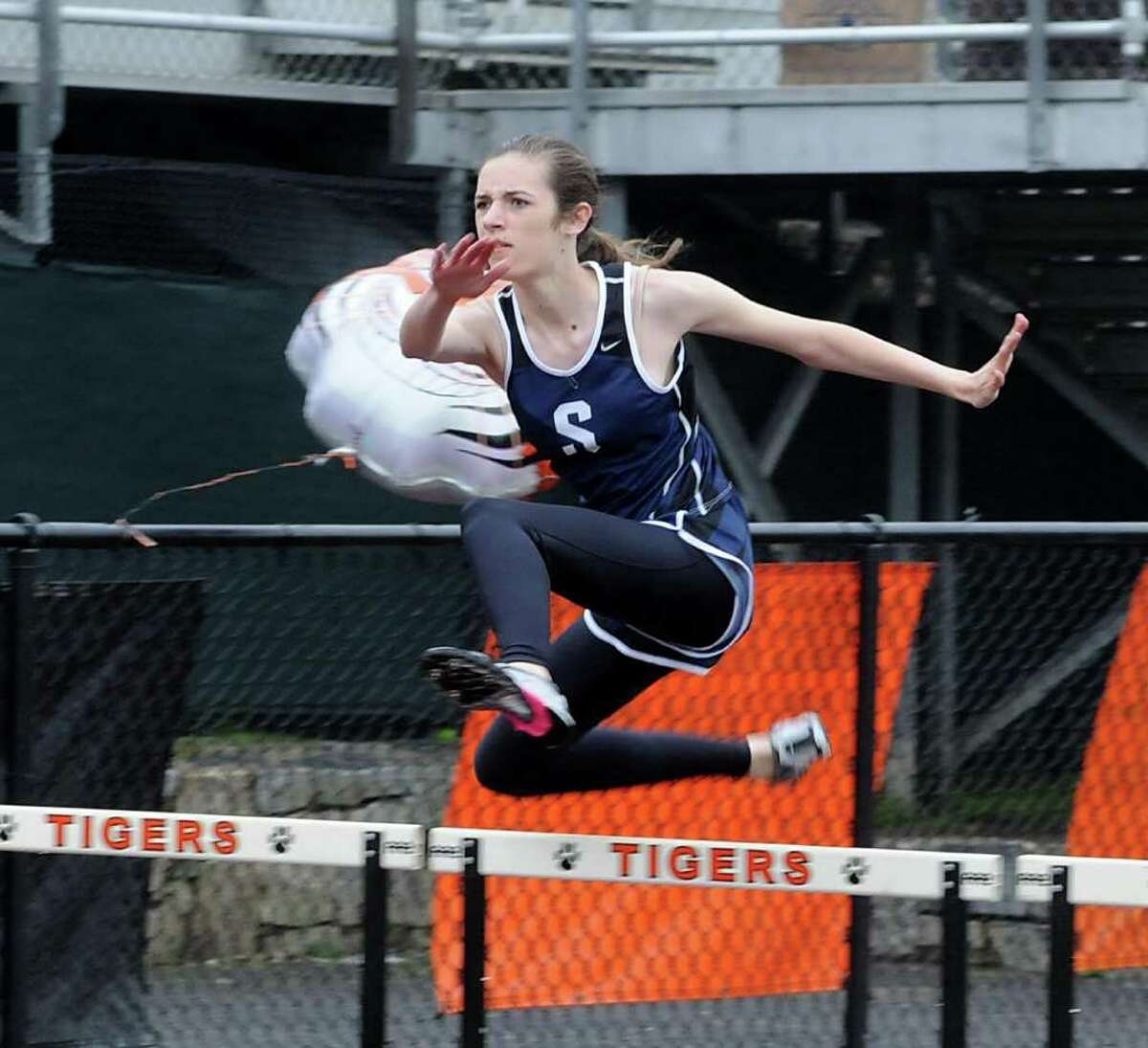 Staples Jennifer Mastrianni jumps hurdles during a track meet at Ridgefield High School on Monday May 17, 2011.