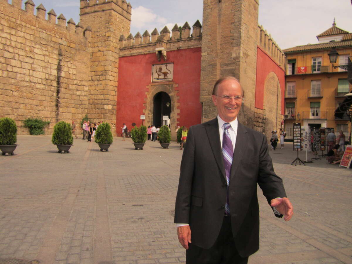 Bexar County Judge Nelson Wolff walks in front of Sevilla's Alcazar, or castle, Monday.