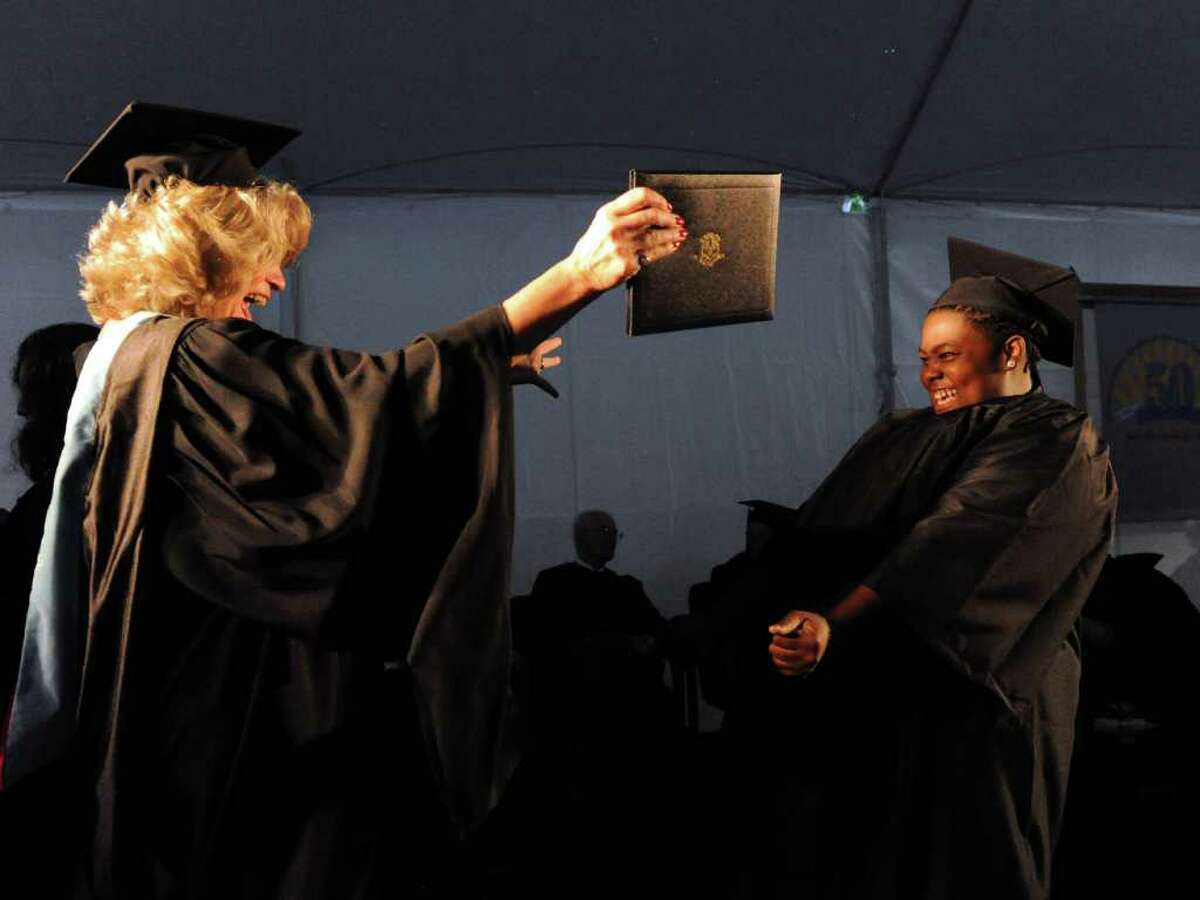Jana Green celebrates her Early Childhood Education Associate's Degree with Program Director Kathy Coppola, left, during the 2011 commencement ceremony at Norwalk Community College in Norwalk, Conn., May 19, 2011.