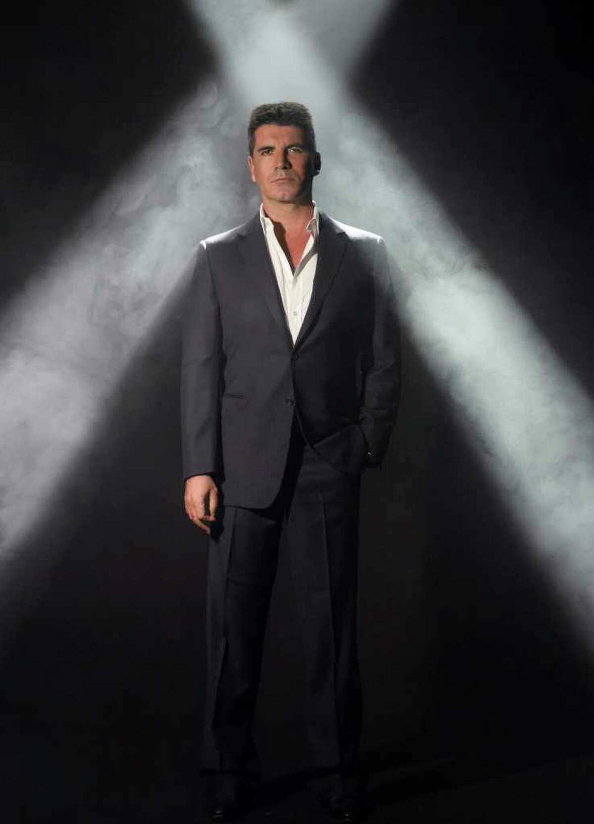 In this undated publicity photo released by Fox, Simon Cowell, from "The X Factor," is shown. Fox, as part of its new season schedule announcement on Monday, May 16, 2011, said it will introduce eight new series next year. They include Simon Cowell's talent show "The X Factor," which was given time slots in the fall similar to "American Idol." (AP Photo/Fox, Ian Derry)