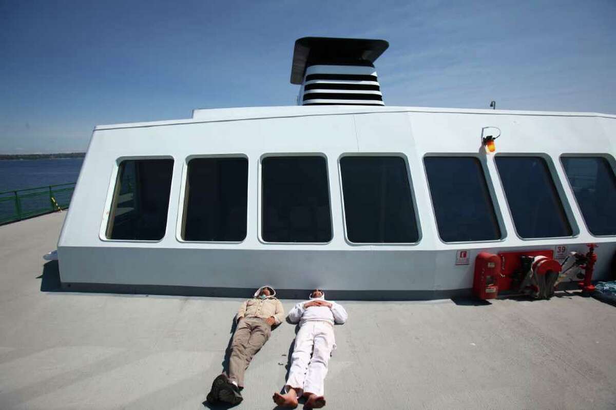 Passengers aboard the M/V Wenatchee catch some rays during a run between Seattle and Bainbridge Island.