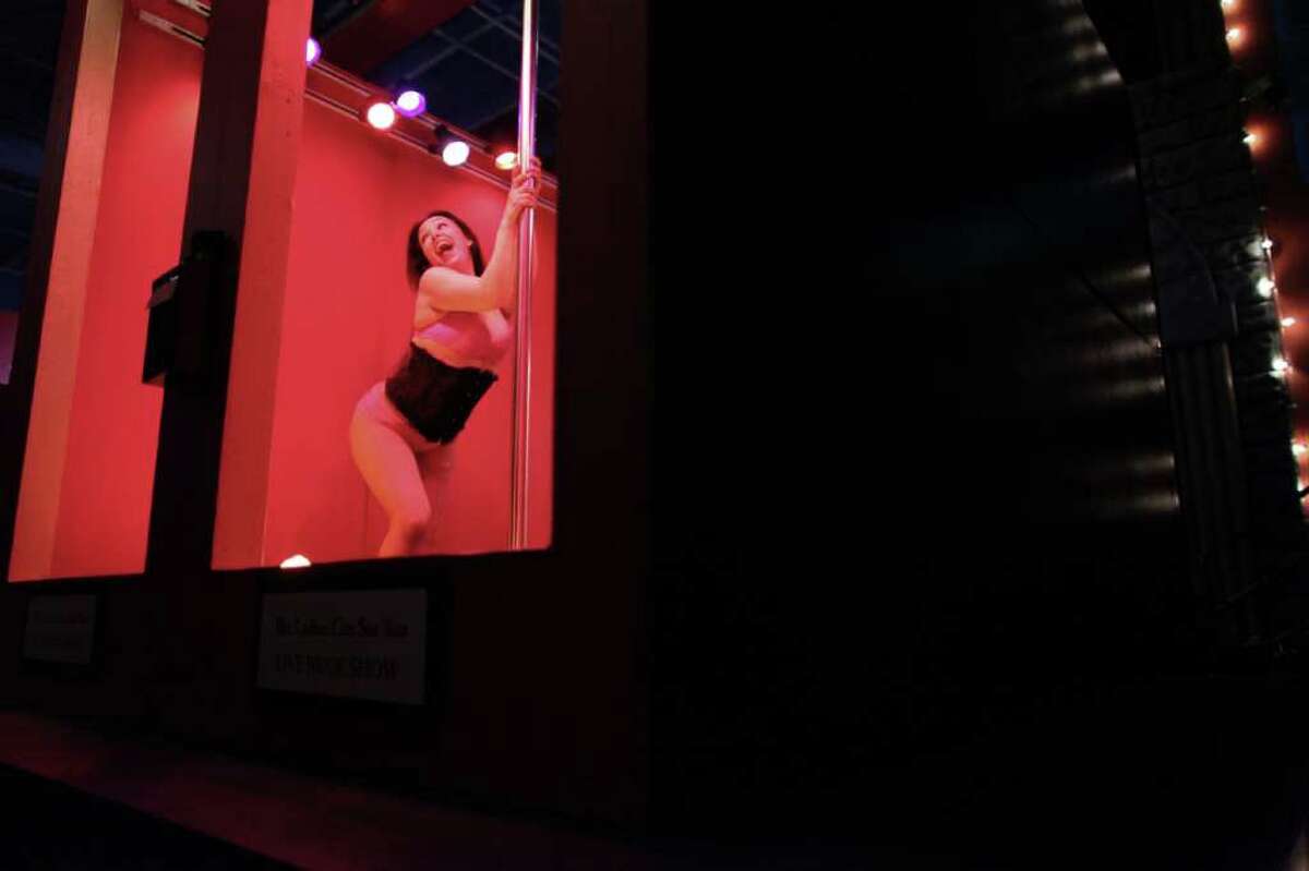 A dancer performs in the Lusty Lady booth.