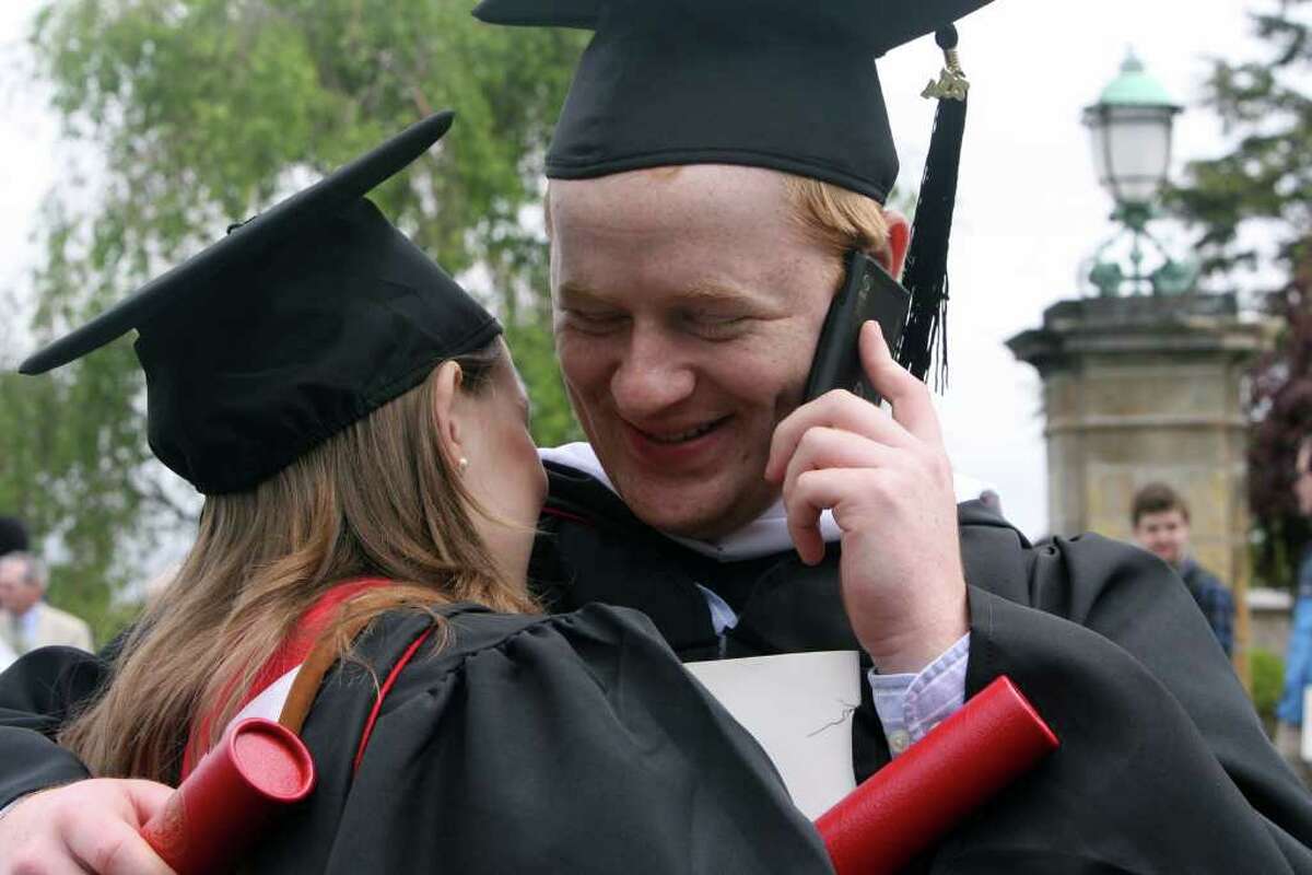 Heather Boyd, of IN, gets a hug from her boyfriend, Jameson Cody, of RI, after receiving their diplomas at Fairfield University's Commencement on Sunday, May 22, 2011. Cody was also trying to locate family at the event.