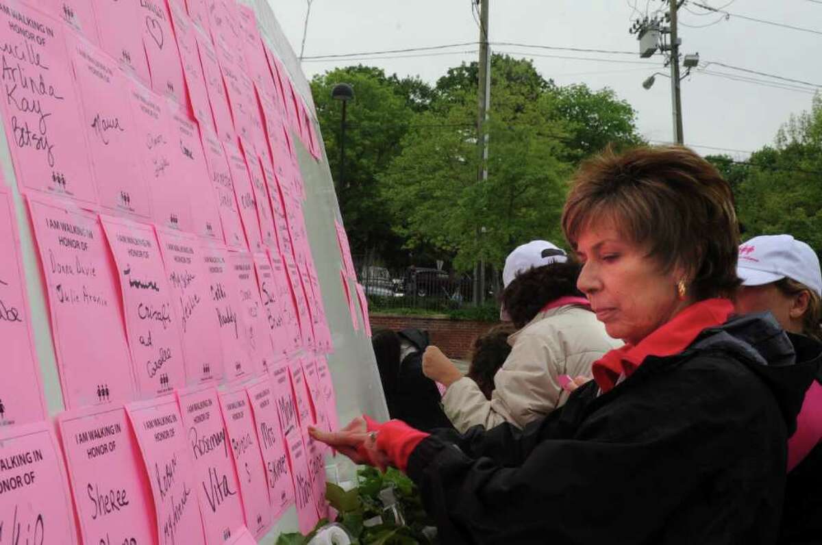 Anna Marie Vlad, of Greenwich, a breast cancer surviver puts a note on the bulletin at the Breast Cancer Alliance sixth annual Hands Across the Avenue on Sunday, May 22, 2011.
