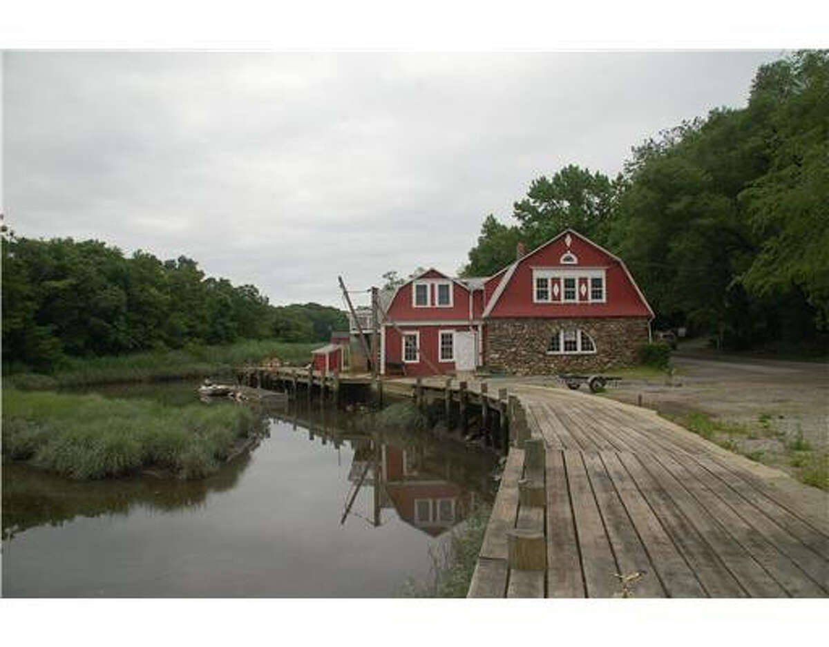 The historic red building on .32 acres on a tidal inlet off Riverside Avenue has had many lives – as a sawmill, blacksmith shop, steam laundry, boat building shop and boat repair and marine supply store, with an apartment above. Fully rented, the building still has living quarters on the second level and an exercise studio and office space on the first floor.