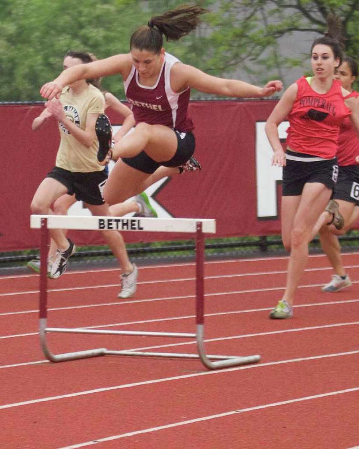 Bethel's Lizzie Morton wins the 300 intermediate hurdles at the SWC Track and Field Championships Monday at Bethel High School.