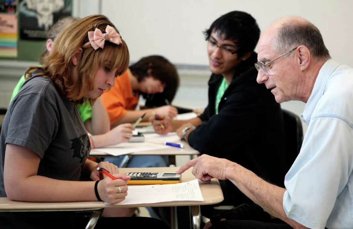Ella Bishop (left) works with Alamo Heights High School math teacher Paul Foerster during Algebra II. Foerster will hang up his calculator at the end of this school year. Foerster, now author of several precalculus and calculus textbooks, began his career far from the education realm. Foerster was previously a chemical engineer in the Navy's nuclear propulsion program. During his time in the Navy, he began tutoring and ultimately went back to school to become a teacher.