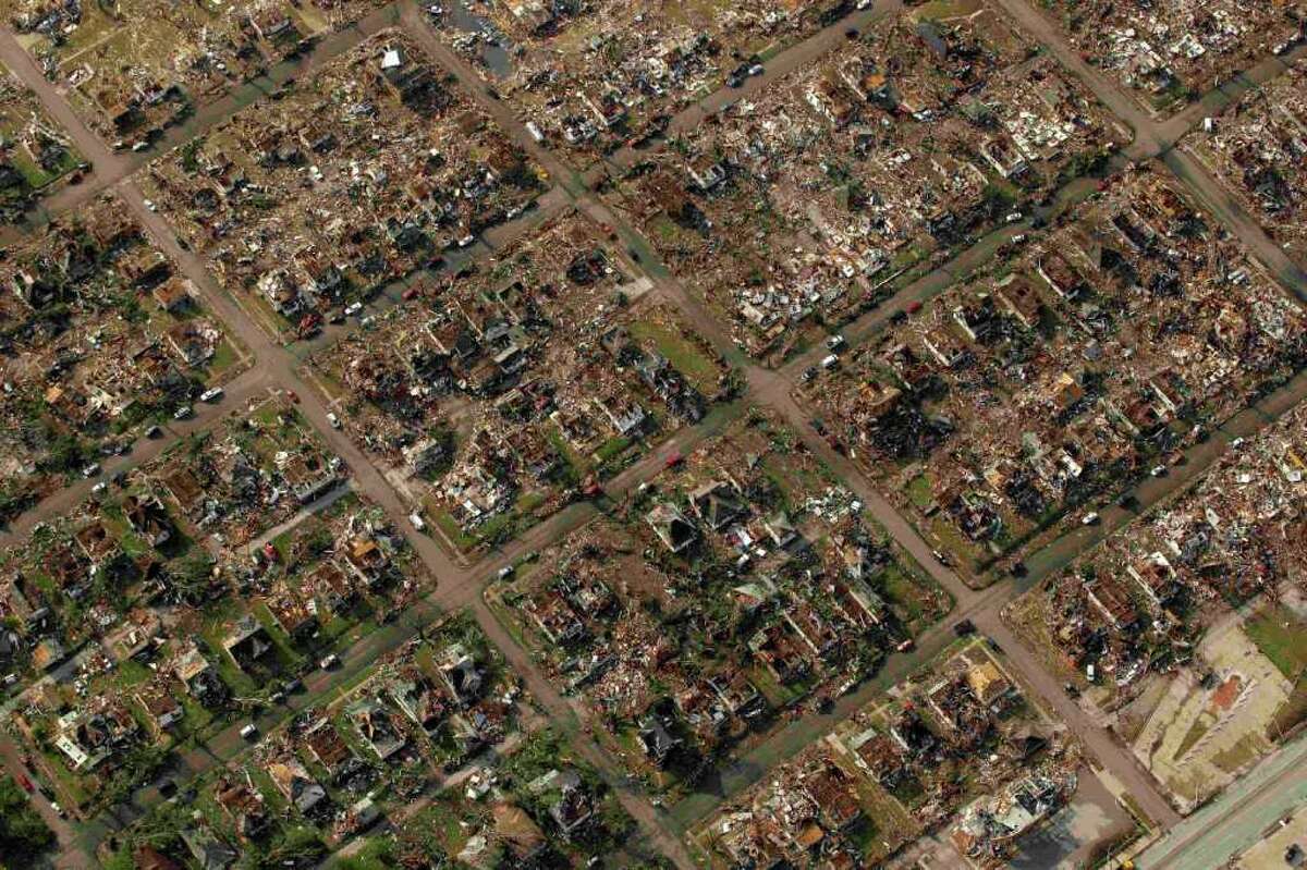 A neighborhood destroyed by a powerful tornado on Sunday is seen in Joplin, Mo. Tuesday, May 24, 2011. A tornado moved through much of the city Sunday, damaging a hospital and hundreds of homes and businesses and killing at least 116 people. (AP Photo/Charlie Riedel)