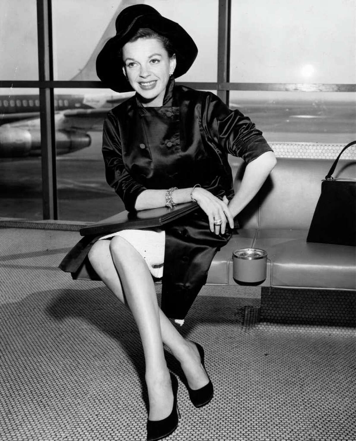 Here's singer and film star Judy Garland at an unidentified airport, circa 1955. Note the ashtray.