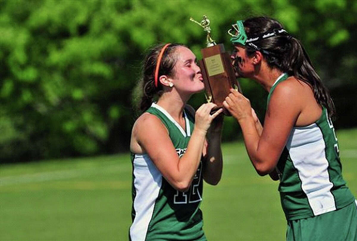 Sacred Heart co-captains Megan Cincotta, left, and Emily Hatton kiss the championship trophy after beating Greenwich Academy in the FAA lacrosse championship.