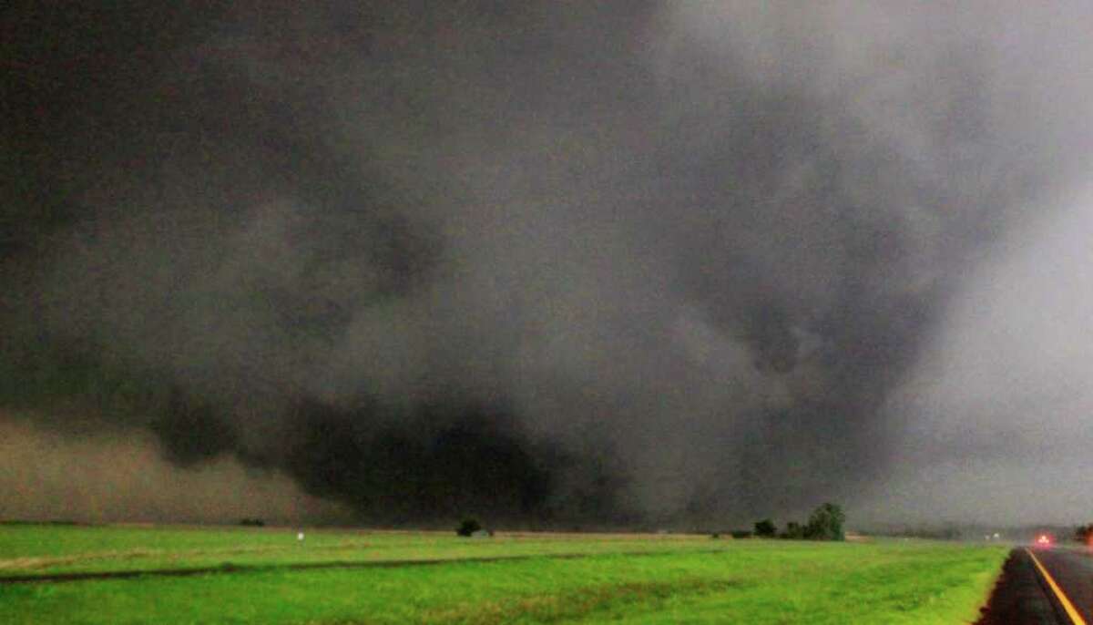 A half-mile-wide tornado moves north in Canadian County after having just crossed SH-3, the Northwest Expressway, west of SH-4 moving towards Piedmont, Okla., on Tuesday.