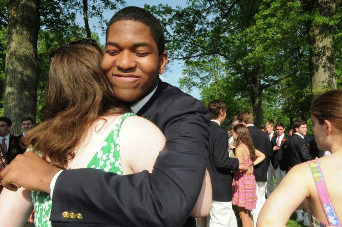 Olivia Harvey gives a hug to Allen Louis after the Brunswich school's 109th commencement on Wednesday, May 25, 2011.