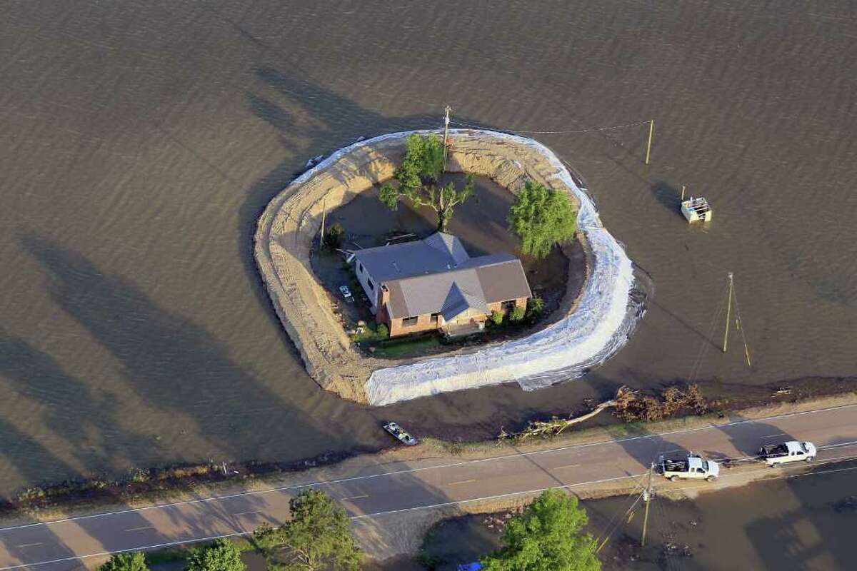 A levee protects a home surrounded by floodwater from the Yazoo River May 18, 2011 near Vicksburg, Miss.
