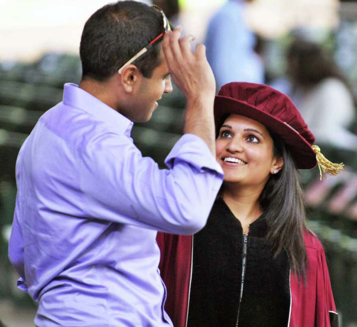 Rachna Patel of Long Island shares a moment with fiance Sid Subramony, left, of New Hampshire before the start of the 173rd Albany Medical College commencement ceremony at SPAC on Thursday. (John Carl D'Annibale / Times Union)