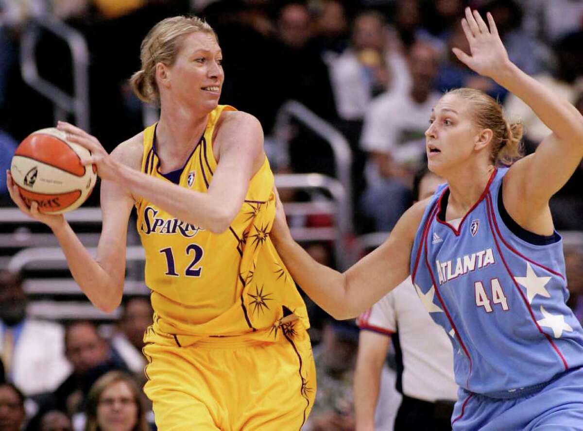 Los Angeles Sparks' Margo Dydek, left, protects the ball as Atlanta Dream's Katie Feenstra, right, defends during Dream's 83-72 victory in a WNBA basketball game on Sept. 11, 2008, in Los Angeles. Dydek has died after suffering a heart attack a week ago and being placed in a medically induced coma. Cathy Roberts, the operations manager for the Northside Wizards in the Queensland Basketball League, where Dydek was head coach, told The Associated Press that Dydek, 37, died early Friday May 27, 2011..