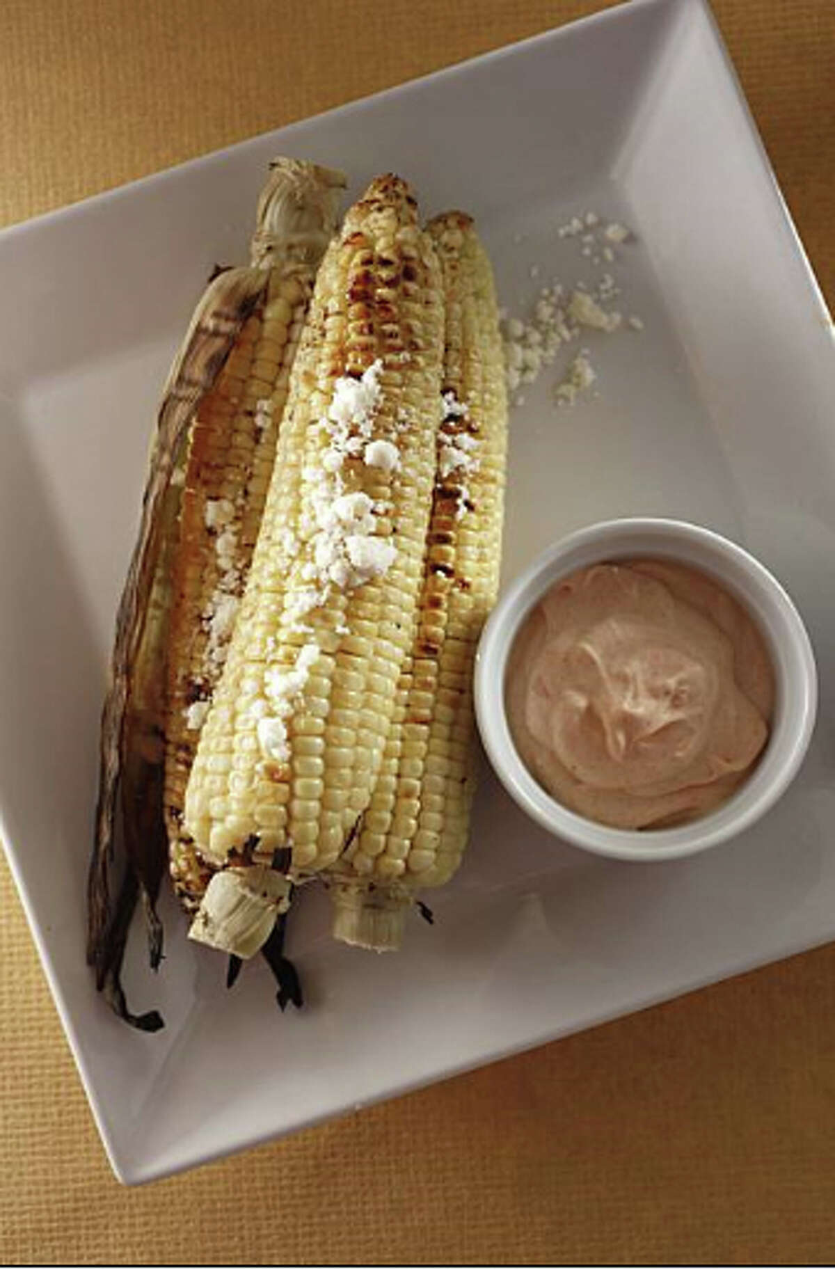 Grilled Corn on the Cob With Spicy Lime Creme Fraiche & Cotija Cheese: An upscale spin on the traditional Mexican street food. Recipe: http://www.sfgate.com/food/recipes/detail.html?p=detail&rid=18281&sorig=qs