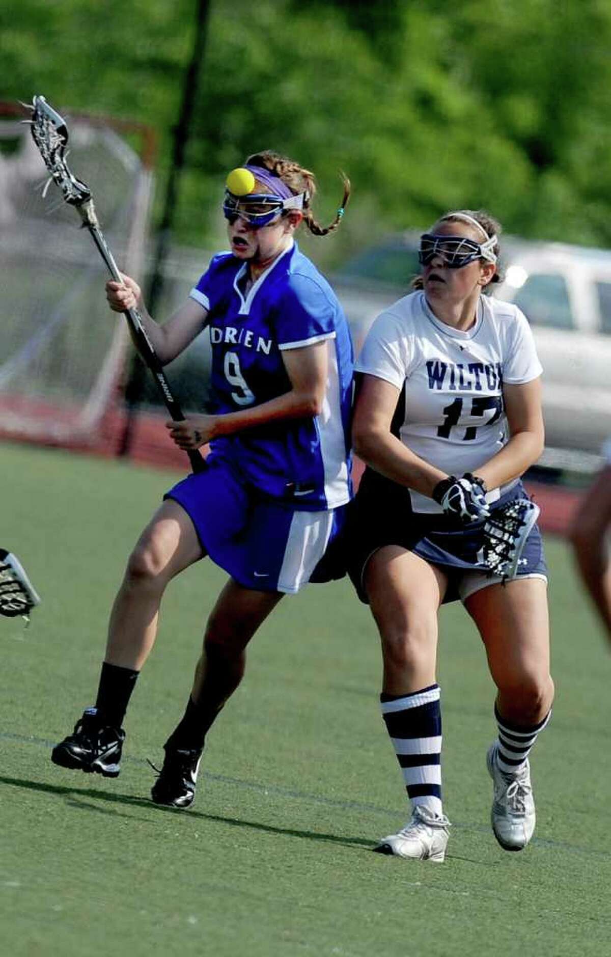 Darien's Emma Stein, left, and Wilton's Liz Reda, right, compete for control of the ball during Friday's FCIAC final at Brien McMahon High School in Norwalk on May 28, 2011.