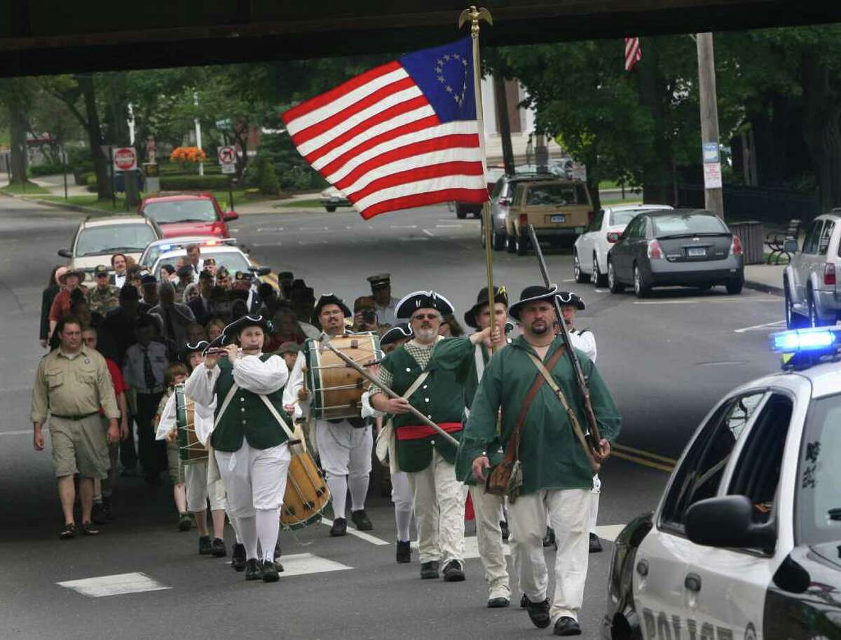 Milford Volunteers Ancient Fife and Drum Corps march during the Milford wreath laying ceremony on Sunday, May 29, 2011.