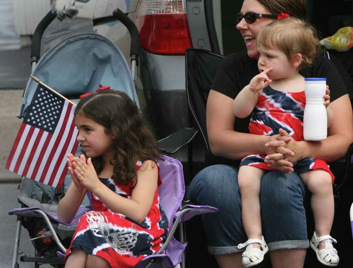Sue Fekete watches the Fairfield Memorial Day Parade parade with her daughters, Emma, 6, and Julia, 17 mos., on Monday, May 30, 2011.