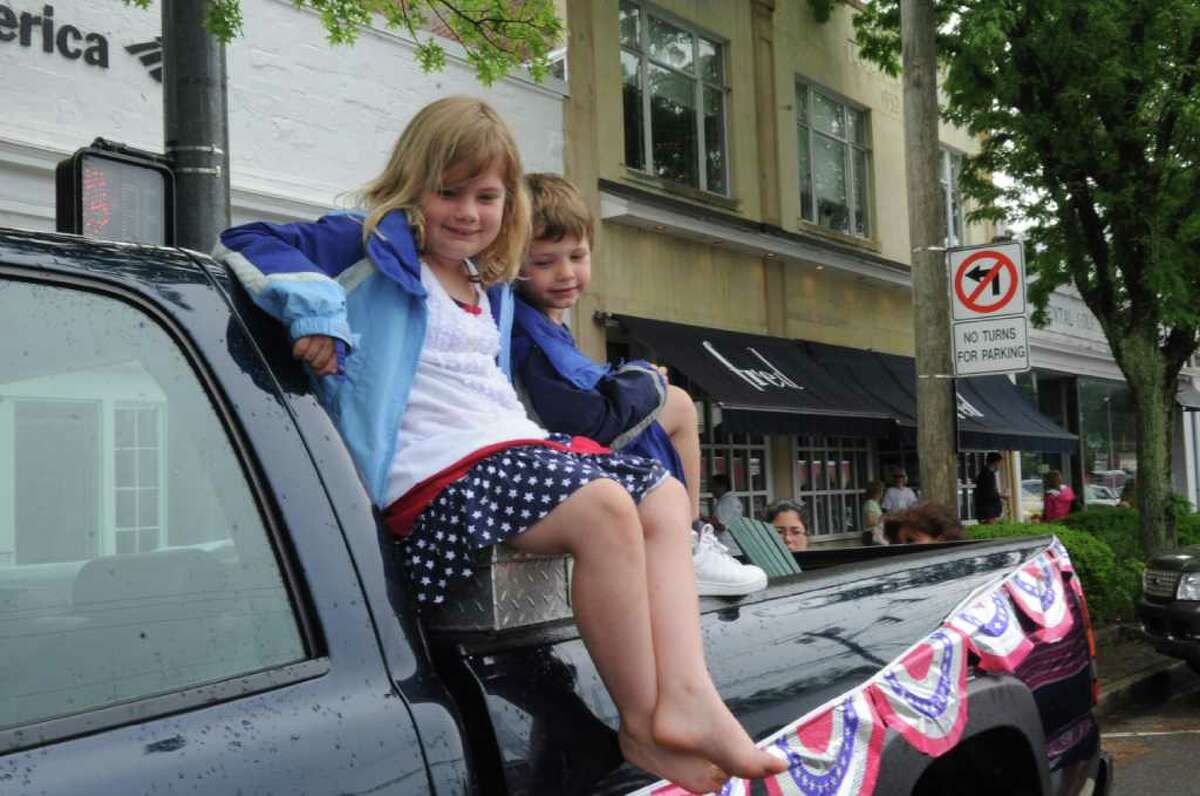 Piper Gilbert, 7, and her brother Reed, 5 watch the Old Greenwich Memorial Day Parade down Sound Beach Avenue on Monday, May 30, 2011.