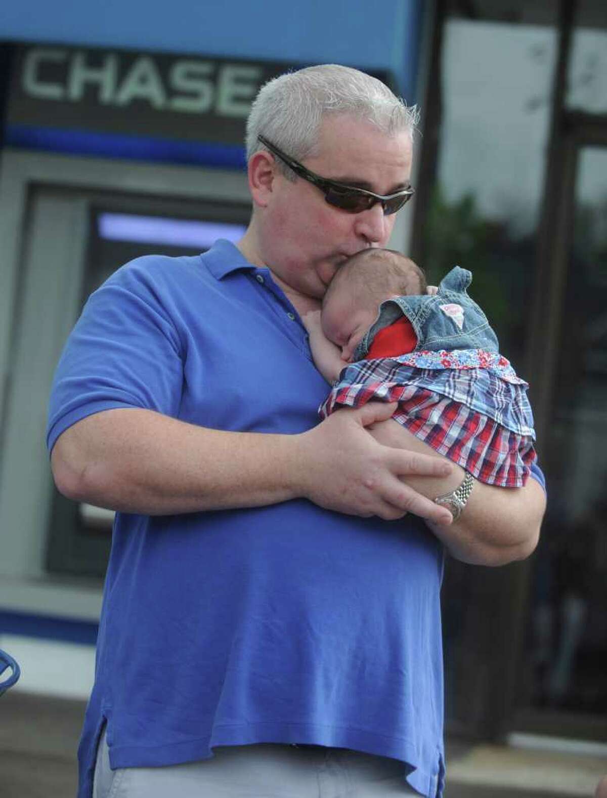 Brian Heavey holds Emma, 3 weeks, waiting the Old Greenwich Memorial Day Parade down Sound Beach Avenue on Monday, May 30, 2011.