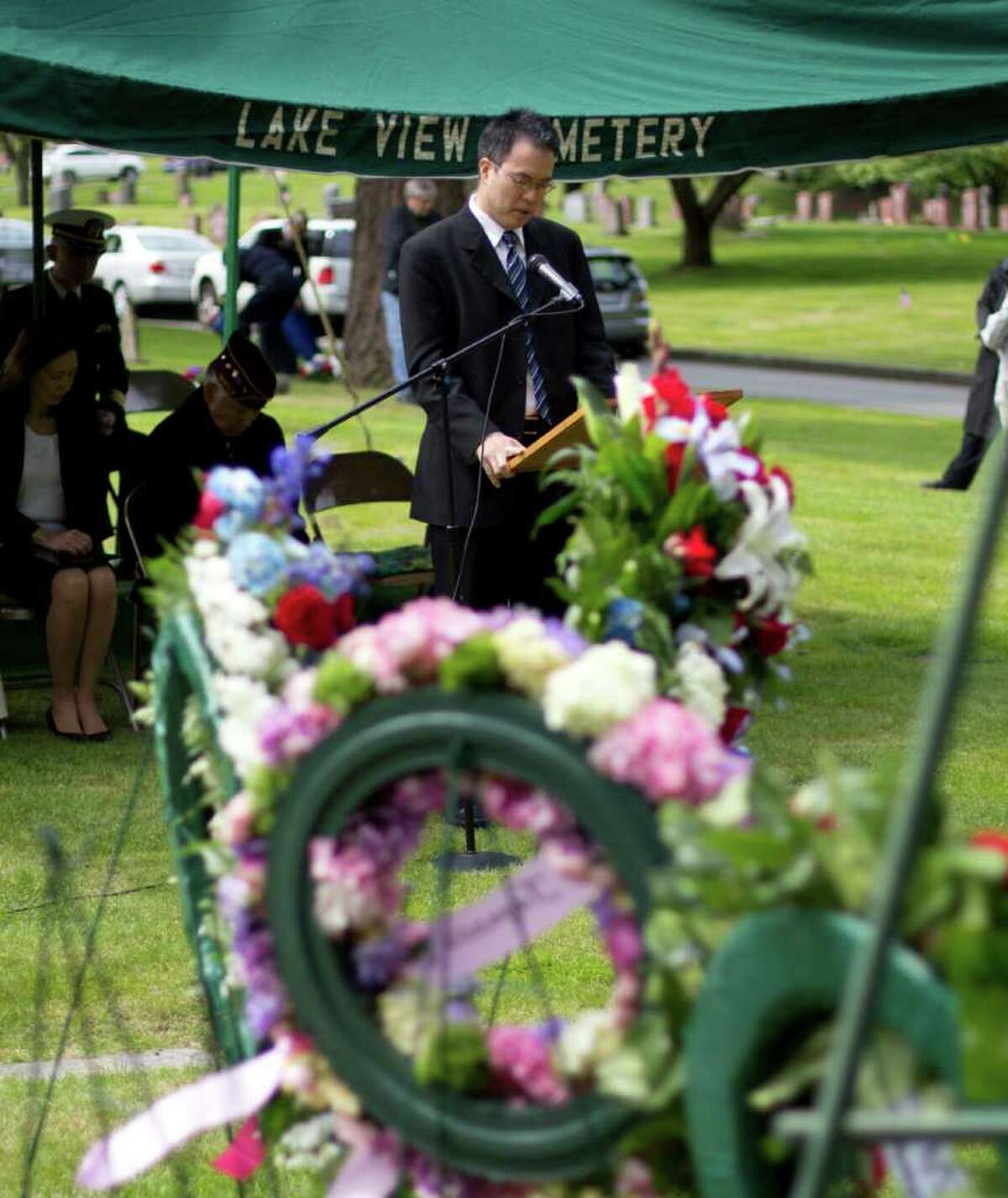 Rev. Dr. J. P. Kang, of the Japanese Presbyterian Church gives a benediction speech in front of the Nisei Veteran Memorial at Seattle's Lake View Cemetery on Memorial Day.