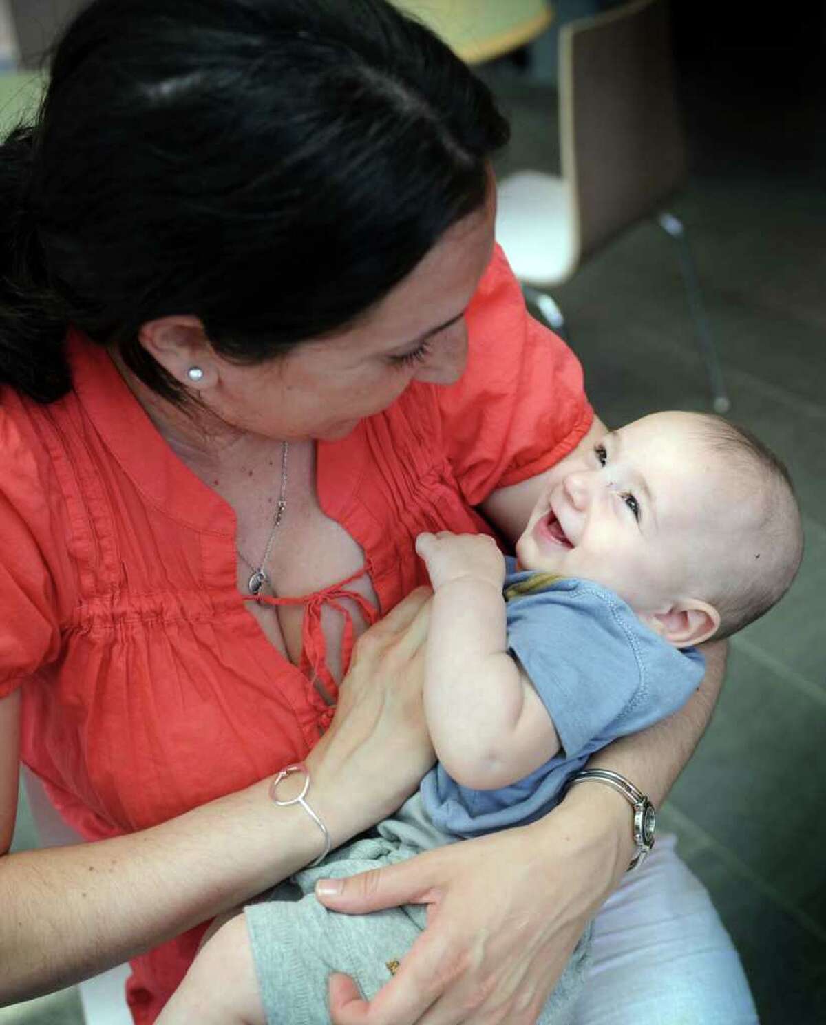 Rhonda Trust-Schwartz, of Fairfield, holds her four-month-old son Ezra during a "nurse-in" at Trumbull Mall Tuesday, May 31, 2011. A group of nursing mothers staged the get together after a woman was allegedly told to "cover-up" while nursing her child in the food court. Trust-Schwartz is policy and advocacy chair for the Connecticut Breastfeeding Coalition as well as a certified Lactation Counselor.