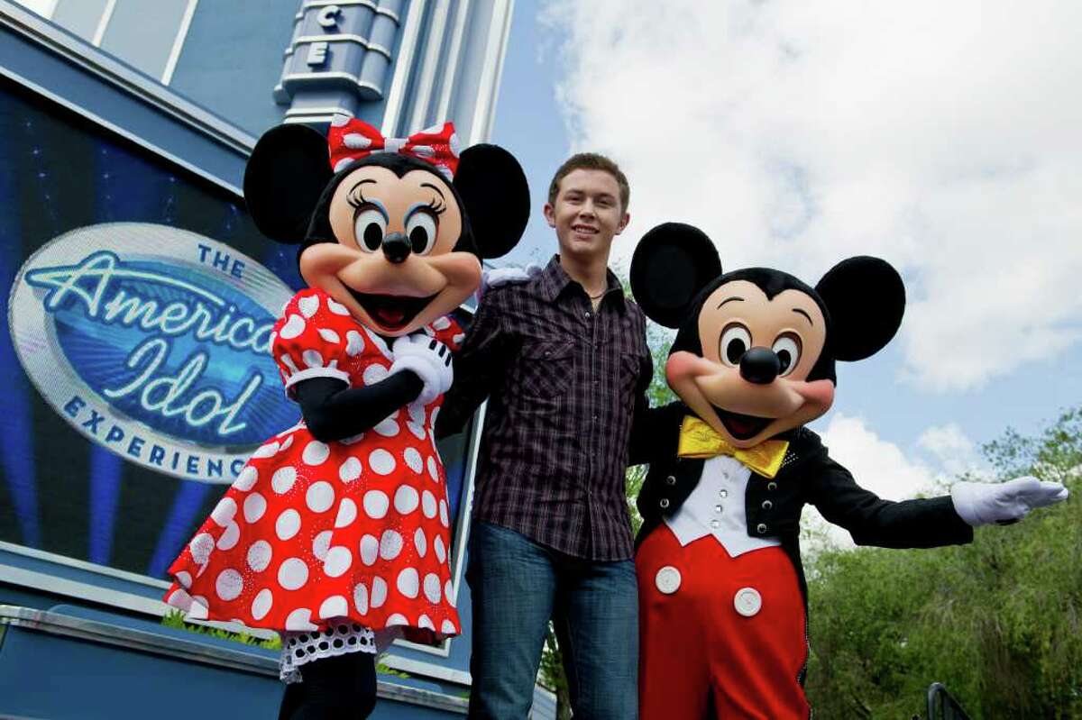 Newly crowned "American Idol" Scotty McCreery poses with Mickey and Minnie Mouse in front of "The American Idol Experience" attraction at Disney's Hollywood Studios in Lake Buena Vista, Florida. McCreery was honored in a parade at the Disney theme park and performed his new song "I Love You This Big." On Wednesday, the 17-year-old singer was crowned the new "American Idol" on the season finale, which was viewed by an estimated 29.3 million people.