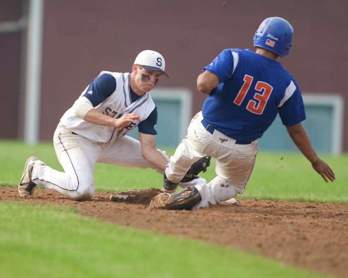 Staples' Mike Scott tags out Danbury's Garron Negron trying to steal during the Class LL state tournament second round game Wednesday at Danbury High School.