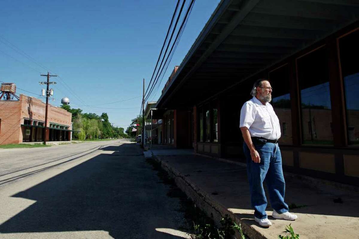 Former Austin and Washington insider Carlton Carl walks around downtown Martindale, just southeast of San Marcos. He bought most of the buildings in downtown Martindale and hopes to bring life to the town.
