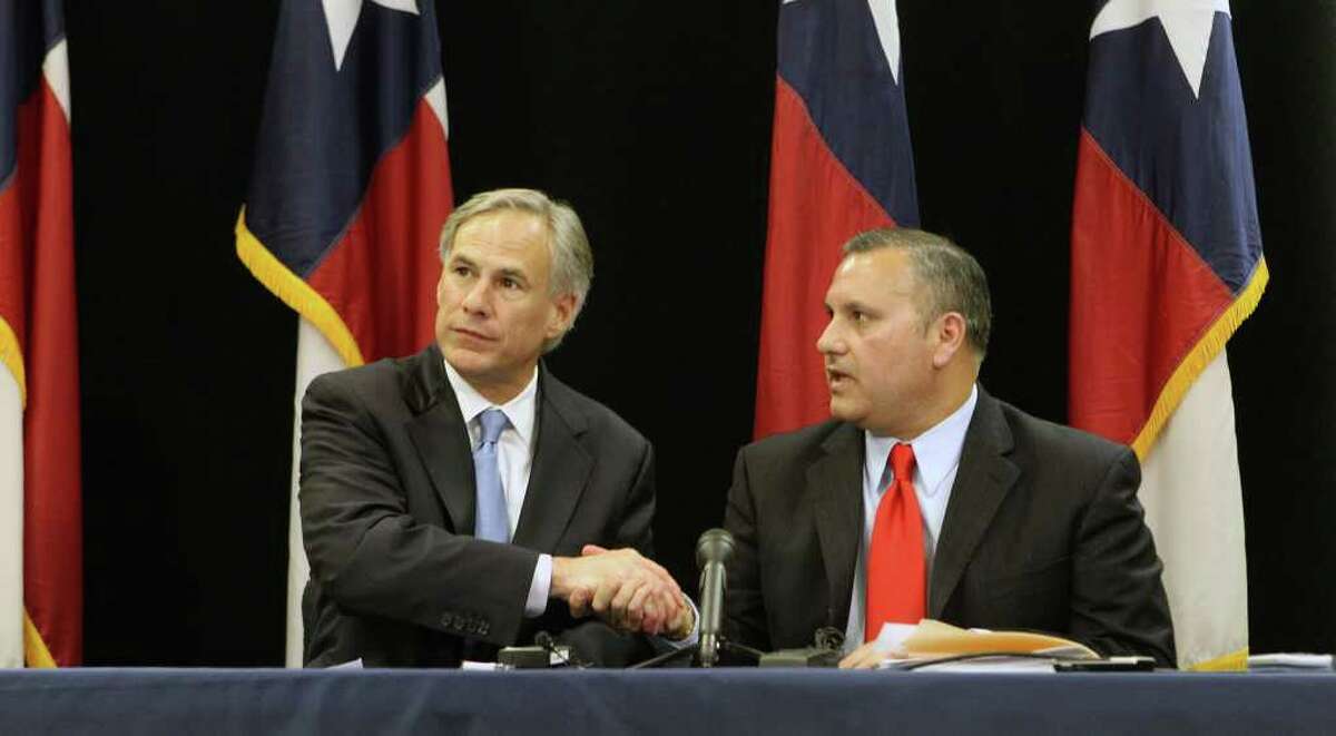 Texas Attorney General Greg Abbott (left) and Medina Valley Assistant Superintendent Chris Martinez after announcing plans to appeal an order banning prayer at graduation.