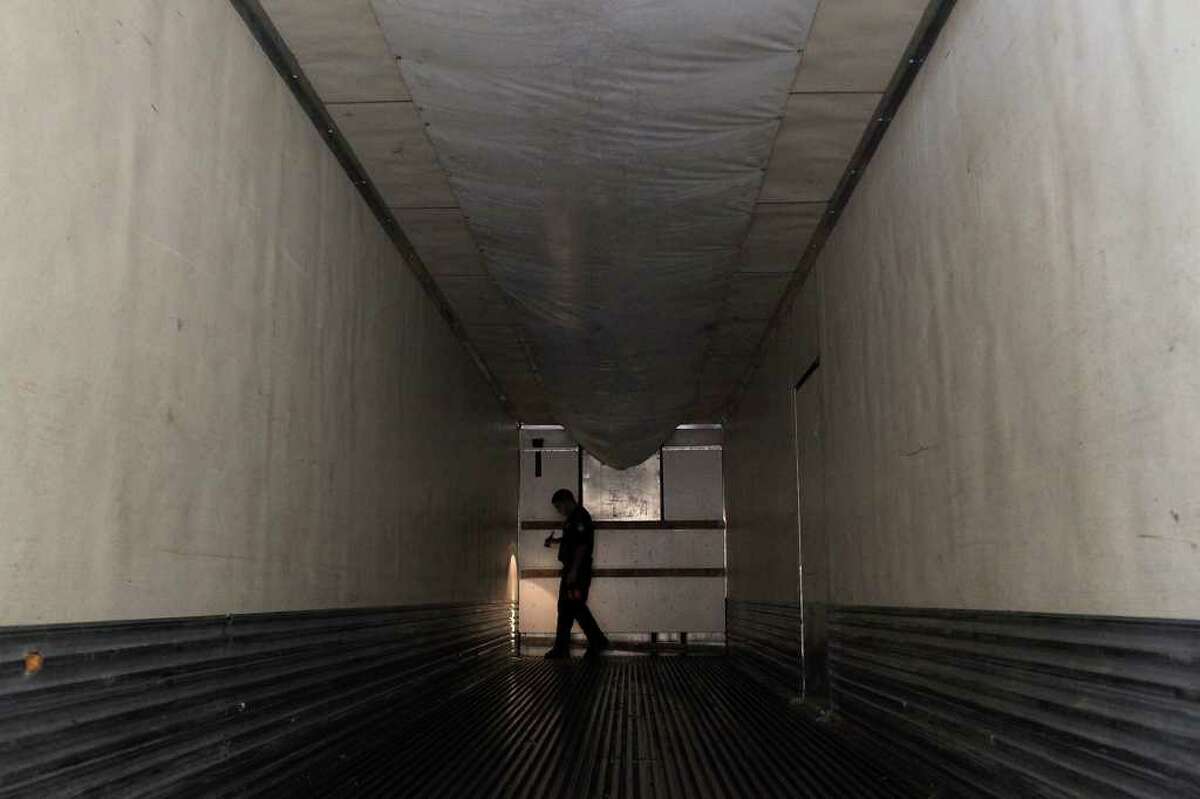 J.A. Flores, a Customs and Border Protection agriculture specialist, inspects the interior of a tractor-trailer after all of its produce has been removed at the Pharr-Reynosa International Bridge Port of Entry.