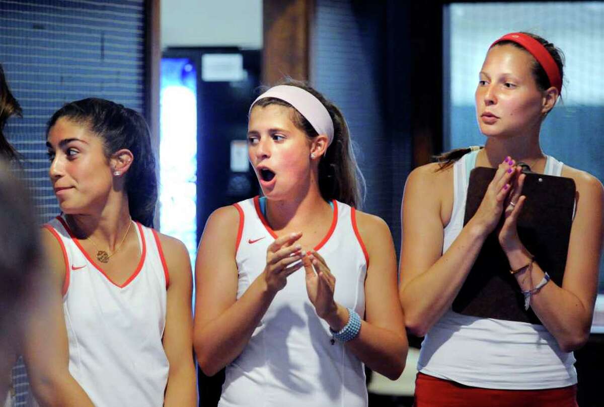 Left to right, Jen DeLuca, Katey Hopper and Michelle Vogt, all of the Greenwich High School girls tennis team cheer during introductions before the girls high school Class L tennis playoff match between Greenwich High School and Staples High School at Sound Shore Indoor Tennis, Port Chester, N.Y., Wednesday afternoon, June 1, 2011.