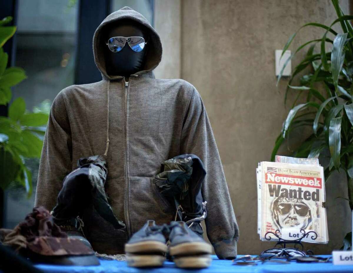 FILE - In this file photo from May 18, 2011, the hoodie and sunglasses used by Ted Kaczynski, also known as the Unabomber, are displayed as Kaczynski's personal items are auctioned off online with proceeds to benefit the victims' families in Atlanta. The online auction of Unabomber memorabilia ends today with bidders vying for the most popular items: hoodie, sunglasses and hand-written manifesto. (AP Photo/David Goldman, file)